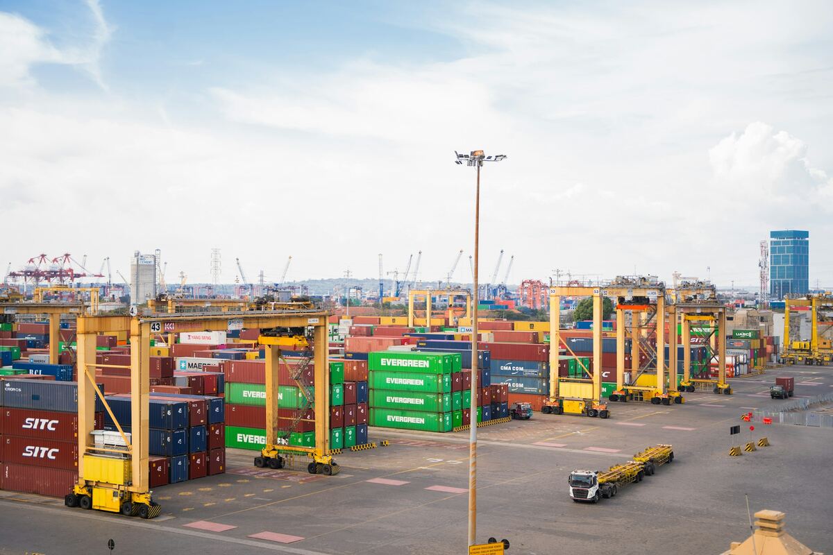Shipping containers and cranes at a working port terminal